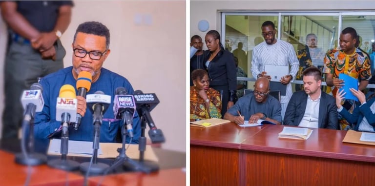 Man in blue jacket speaking at microphones during press conference. Right panel shows officials and attendees seated at a wooden conference table.